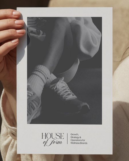 A printed House of Form editorial piece being held.